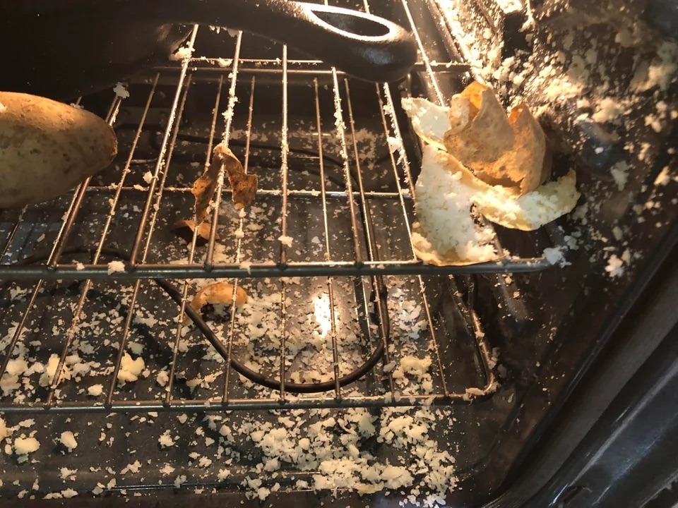 A potato that has exploded in an oven