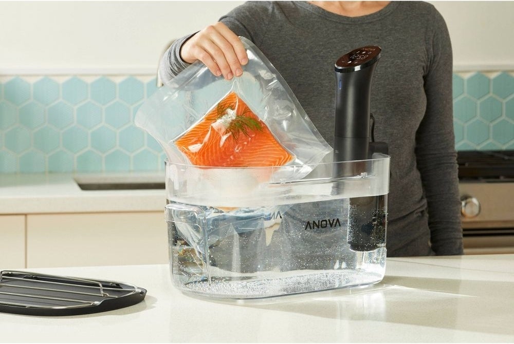 someone using the device to cook salmon