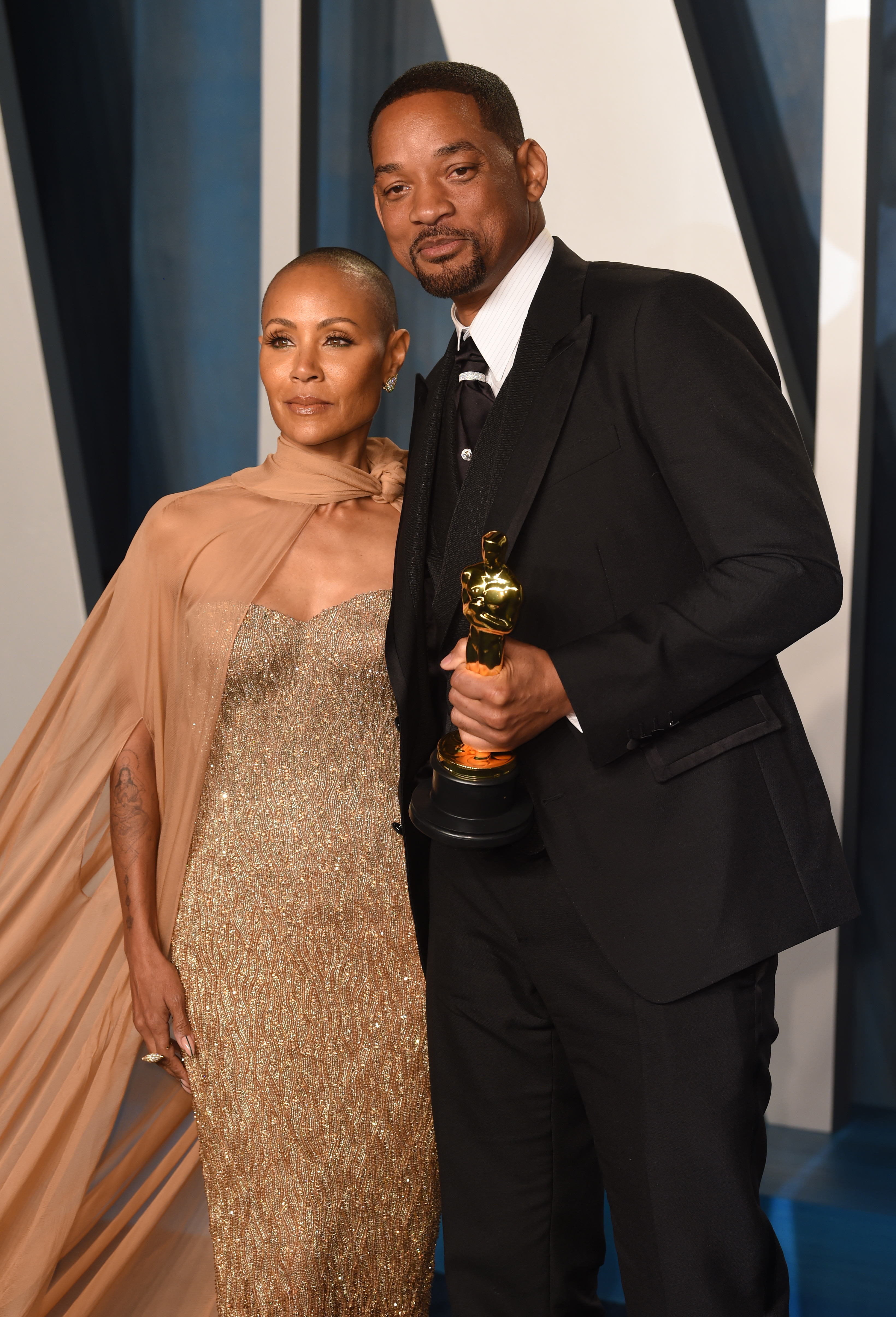 Close-up of Will holding an Oscar while posing for photographers with Jada