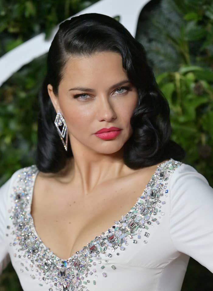 Closeup of Adriana Lima in a long-sleeved dressed with crystals along the neckline