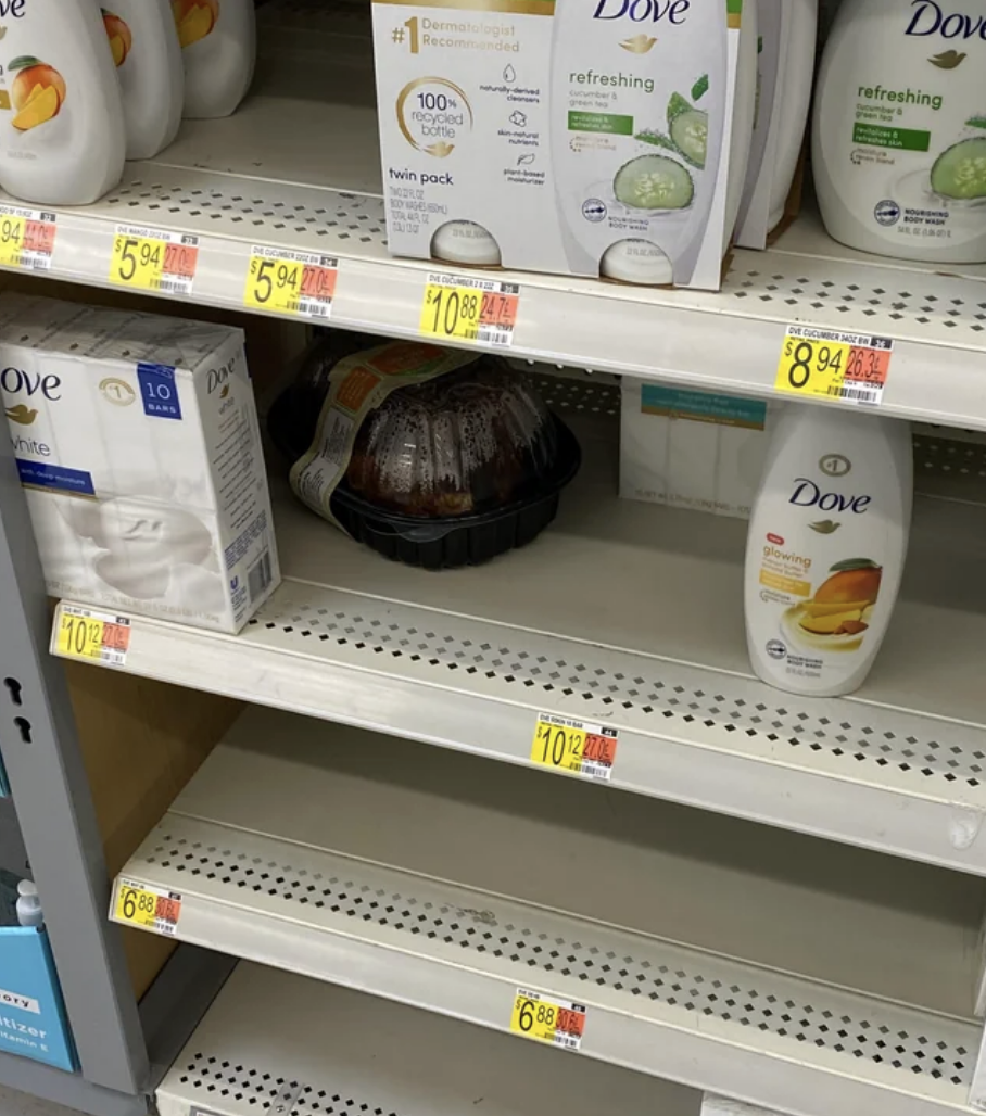 A rotisserie chicken placed in a soap aisle