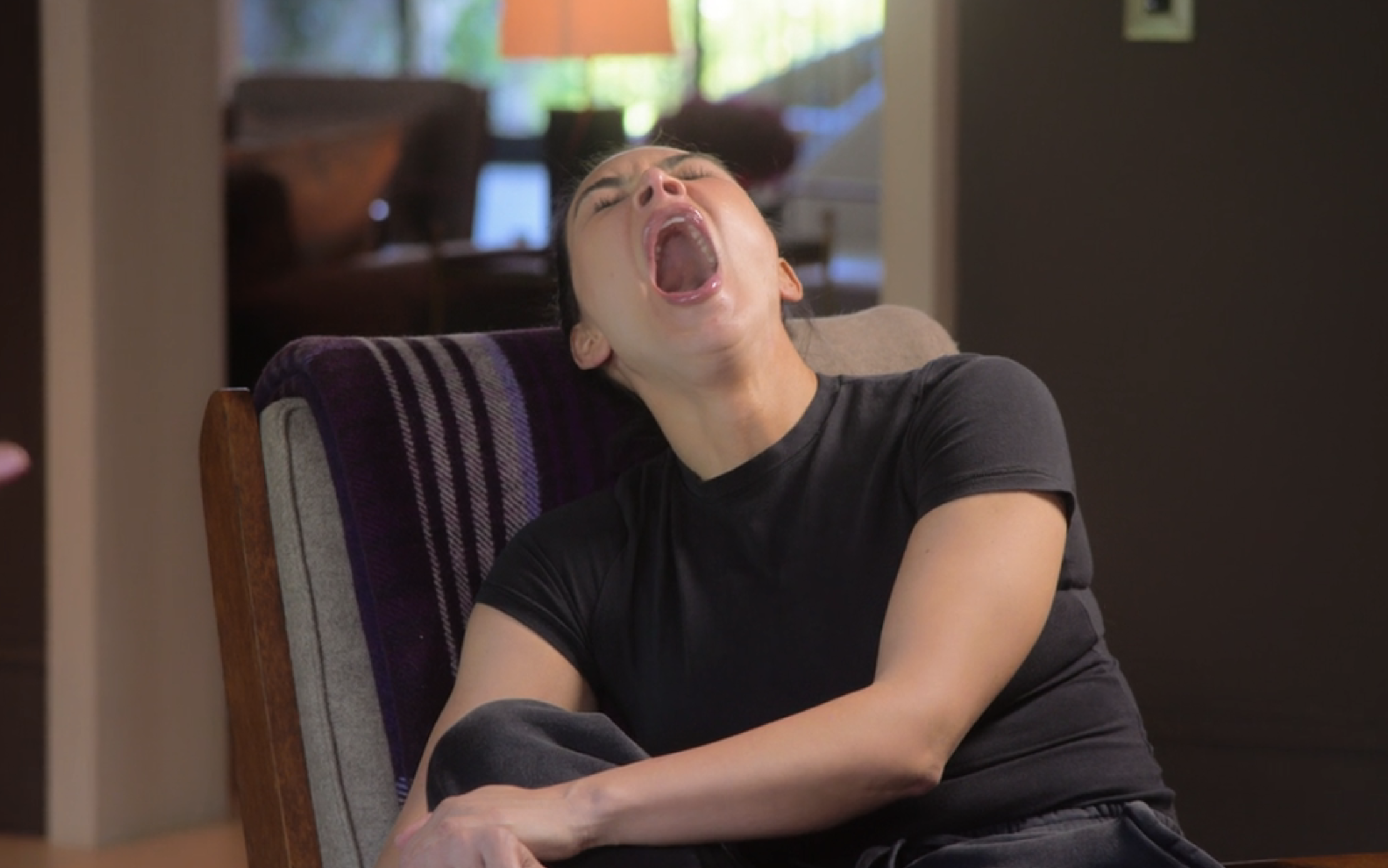 Kim yawning widely
