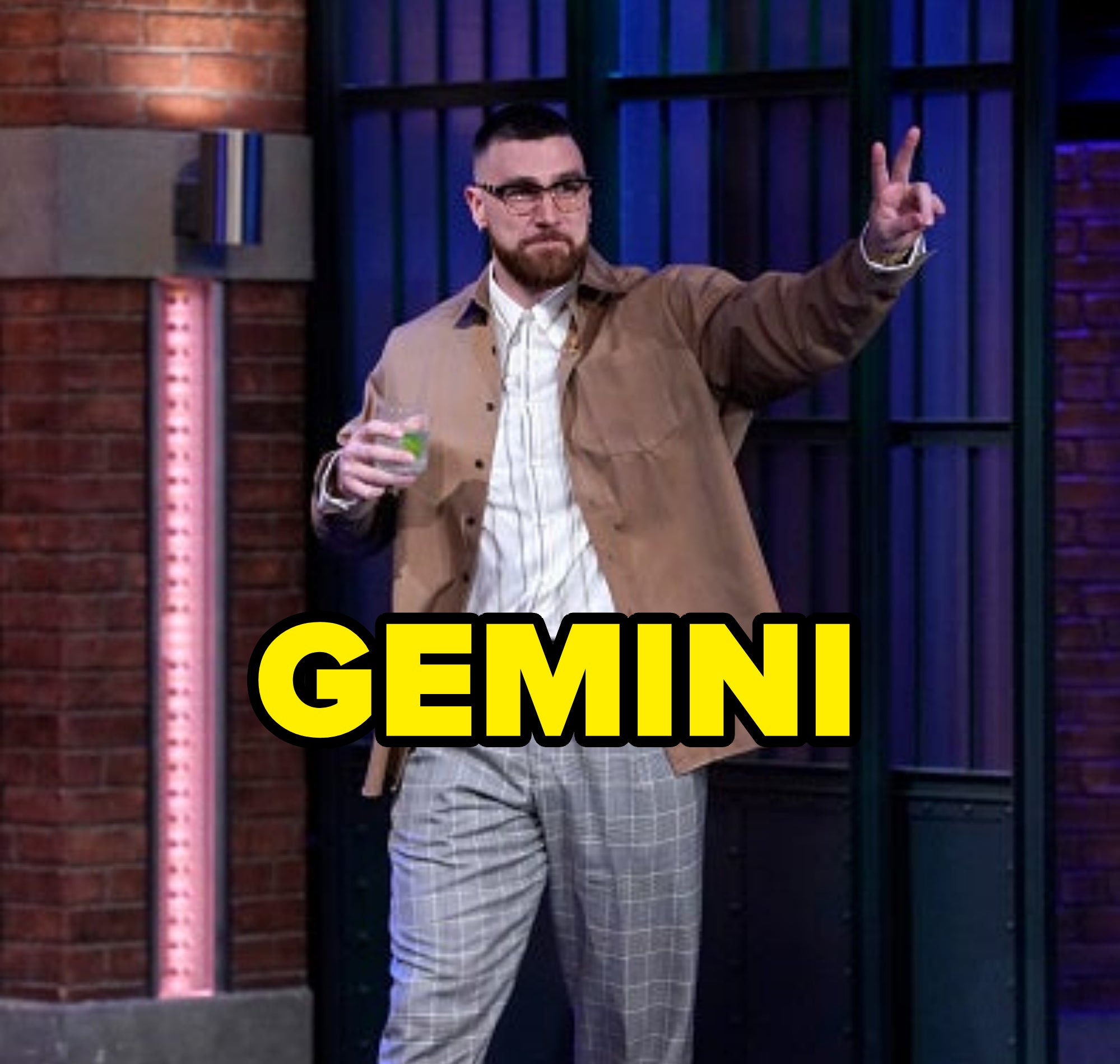 him walking out to a talk show holding a drink and giving the peace with text over reading gemini