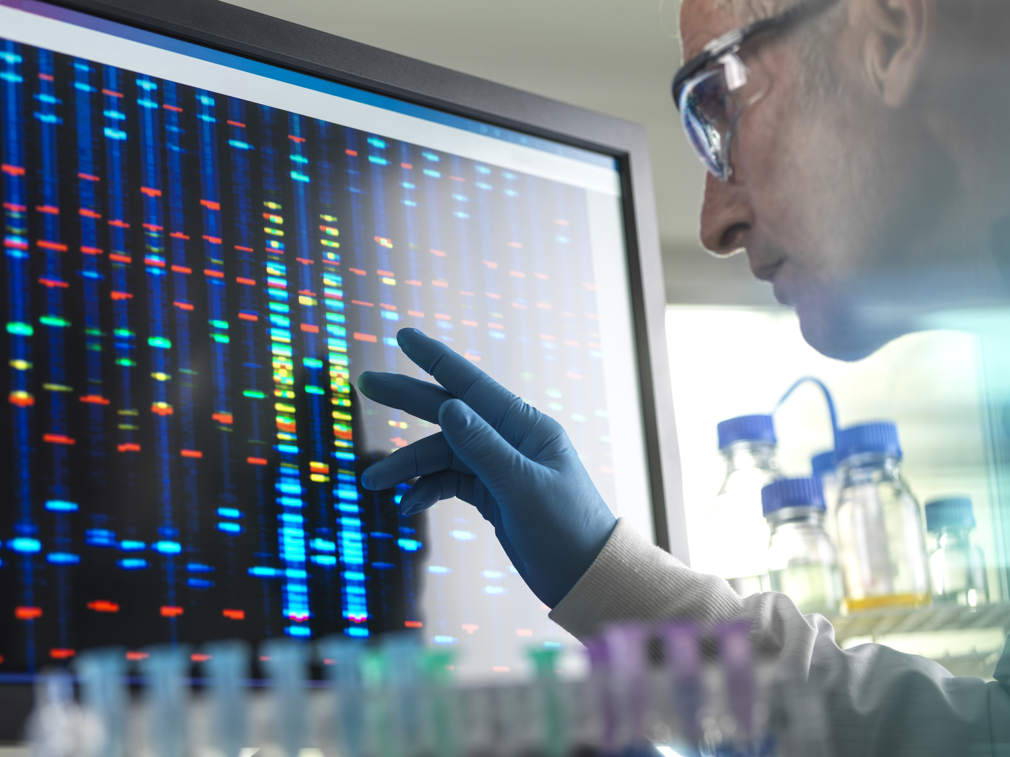 A doctor looking at DNA on a screen