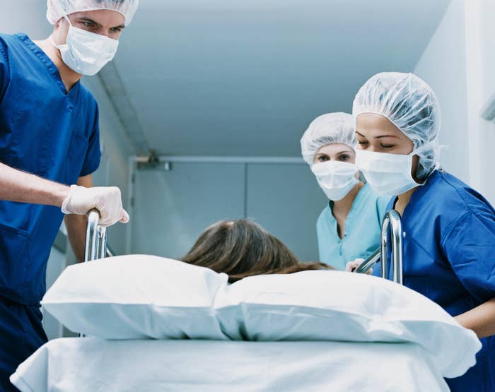 doctors around a patient going into surgery