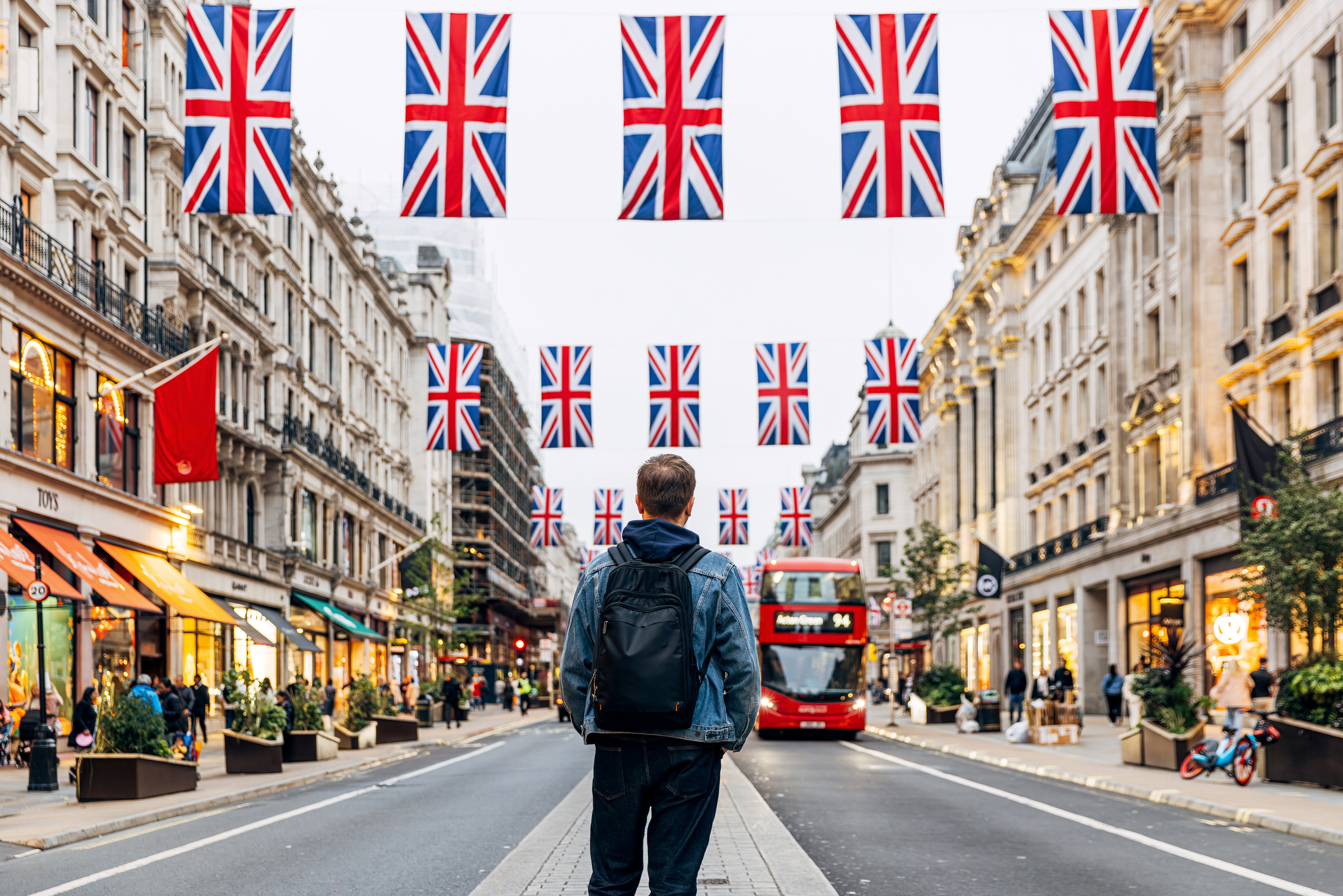 A man on a street with British flags everywhere