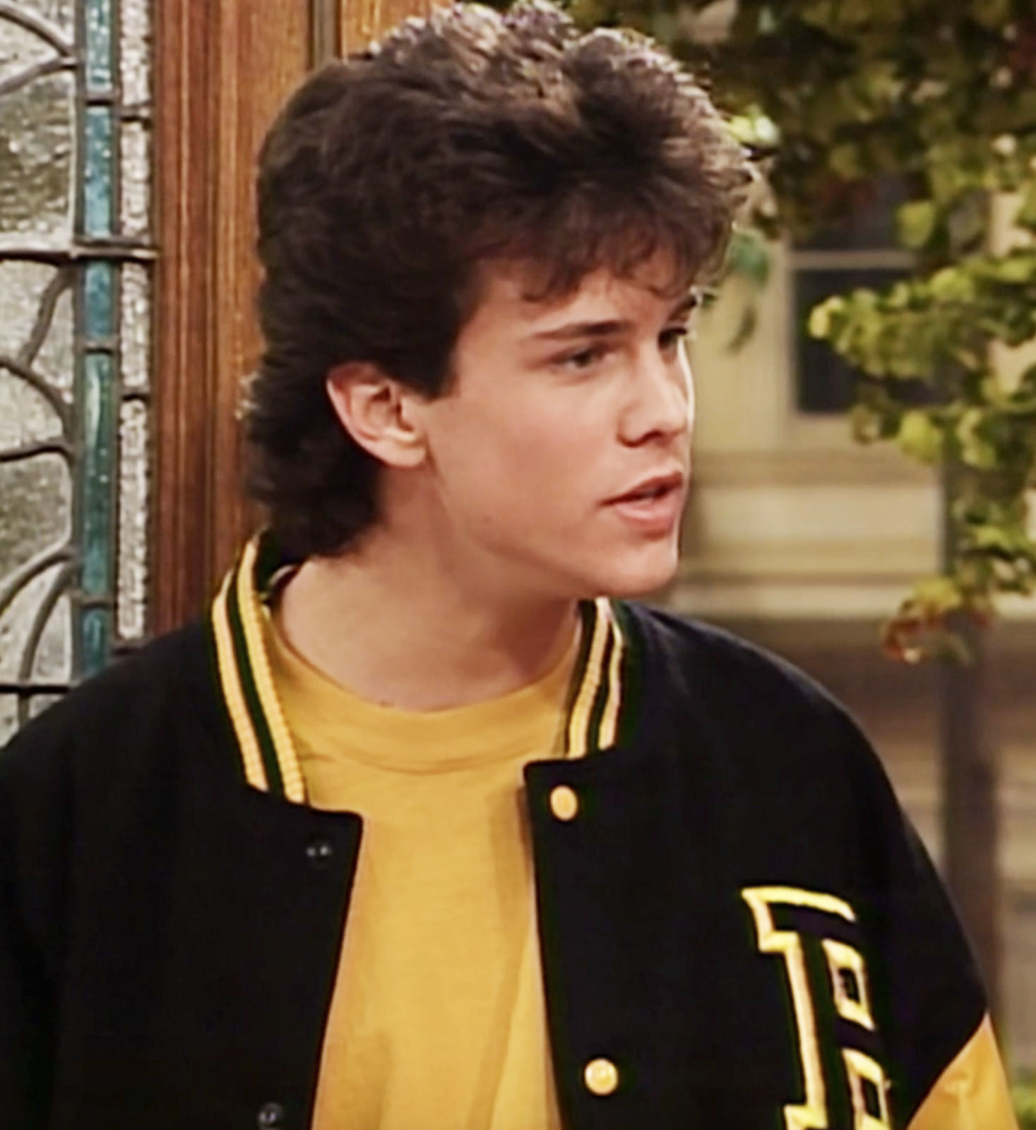 closeup of the character wearing a letterman jacket