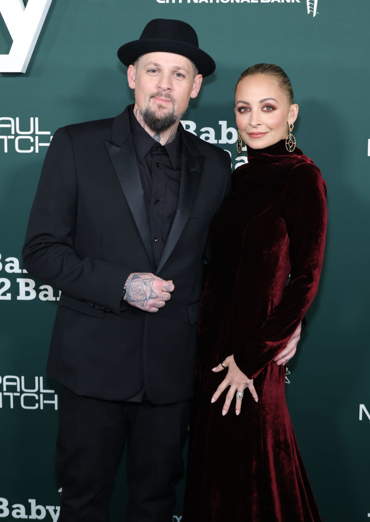 Closeup of Joel Madden and Nicole Richie on the red carpet smiling for photographers
