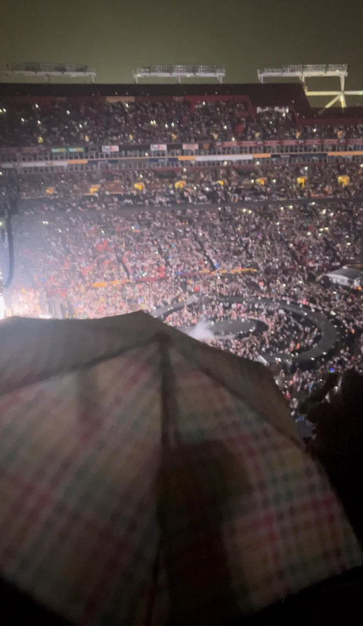 a woman with an umbrella at a concert