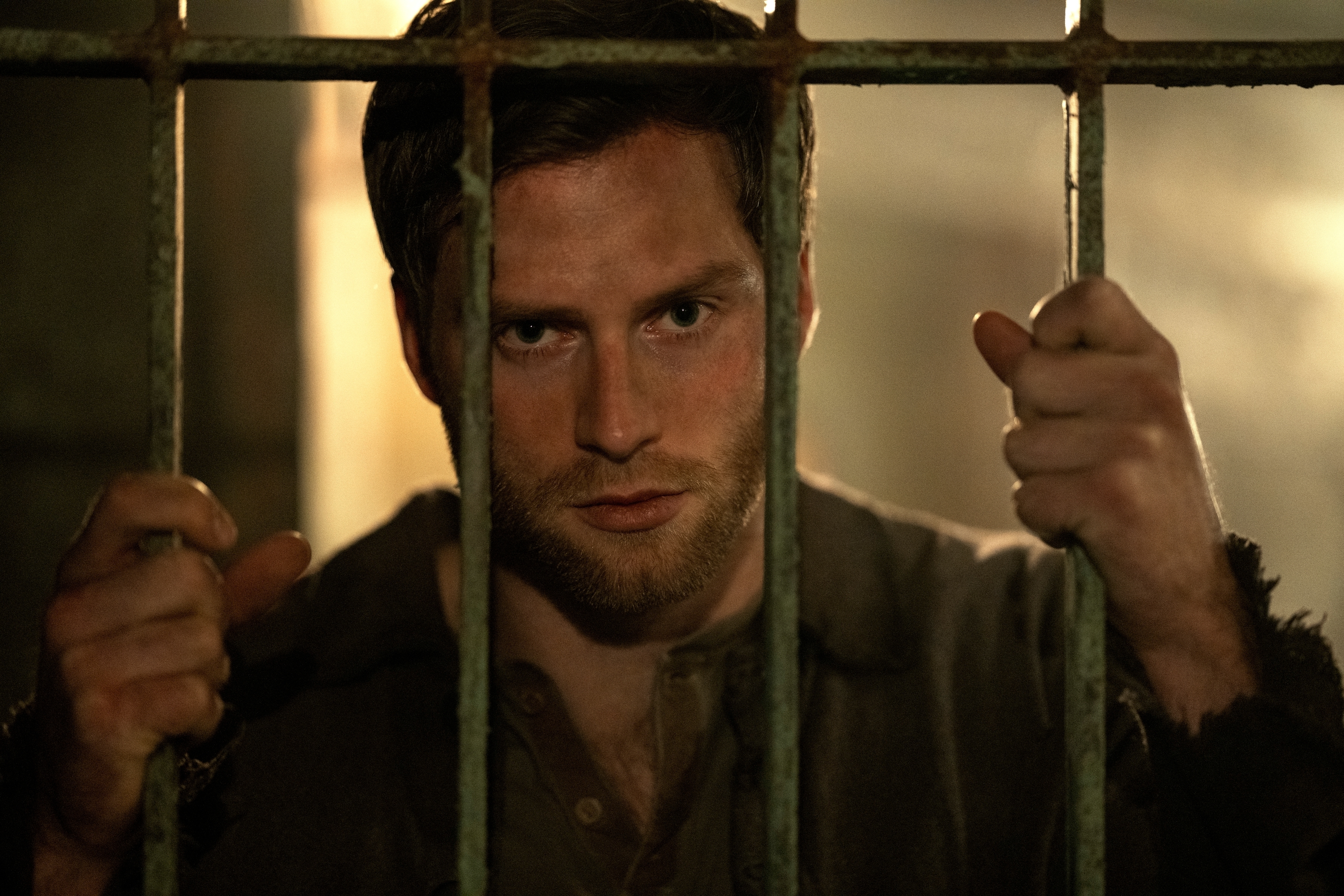 Calahan looking out from behind bars in a scene from &quot;Shadow and Bone&quot;