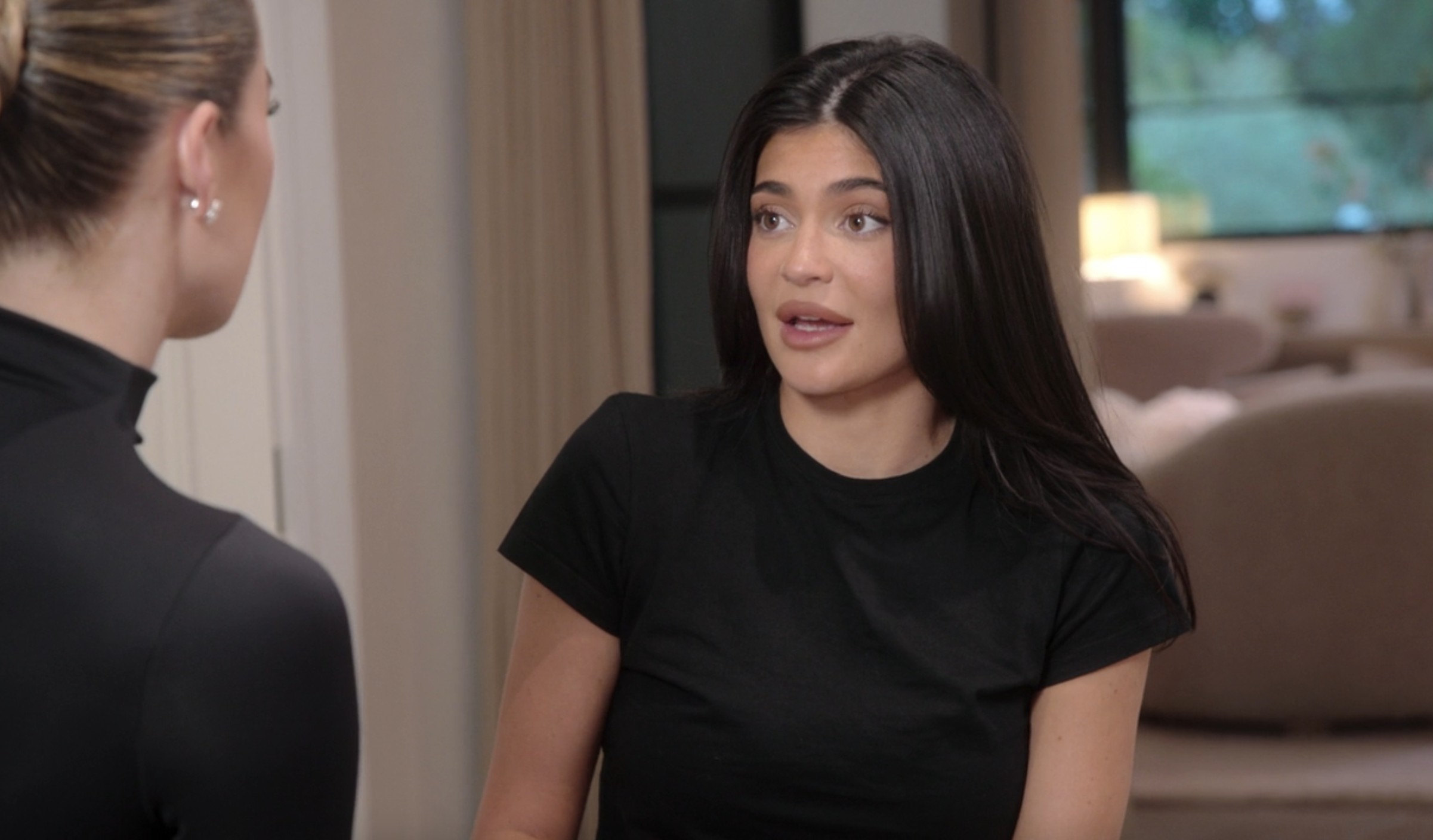 Close-up of Kylie talking to Khloé