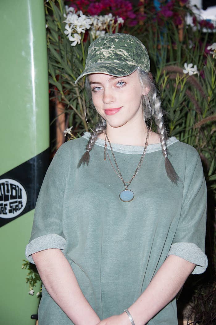 Close-up of Billie smiling in a camo cap and pigtails