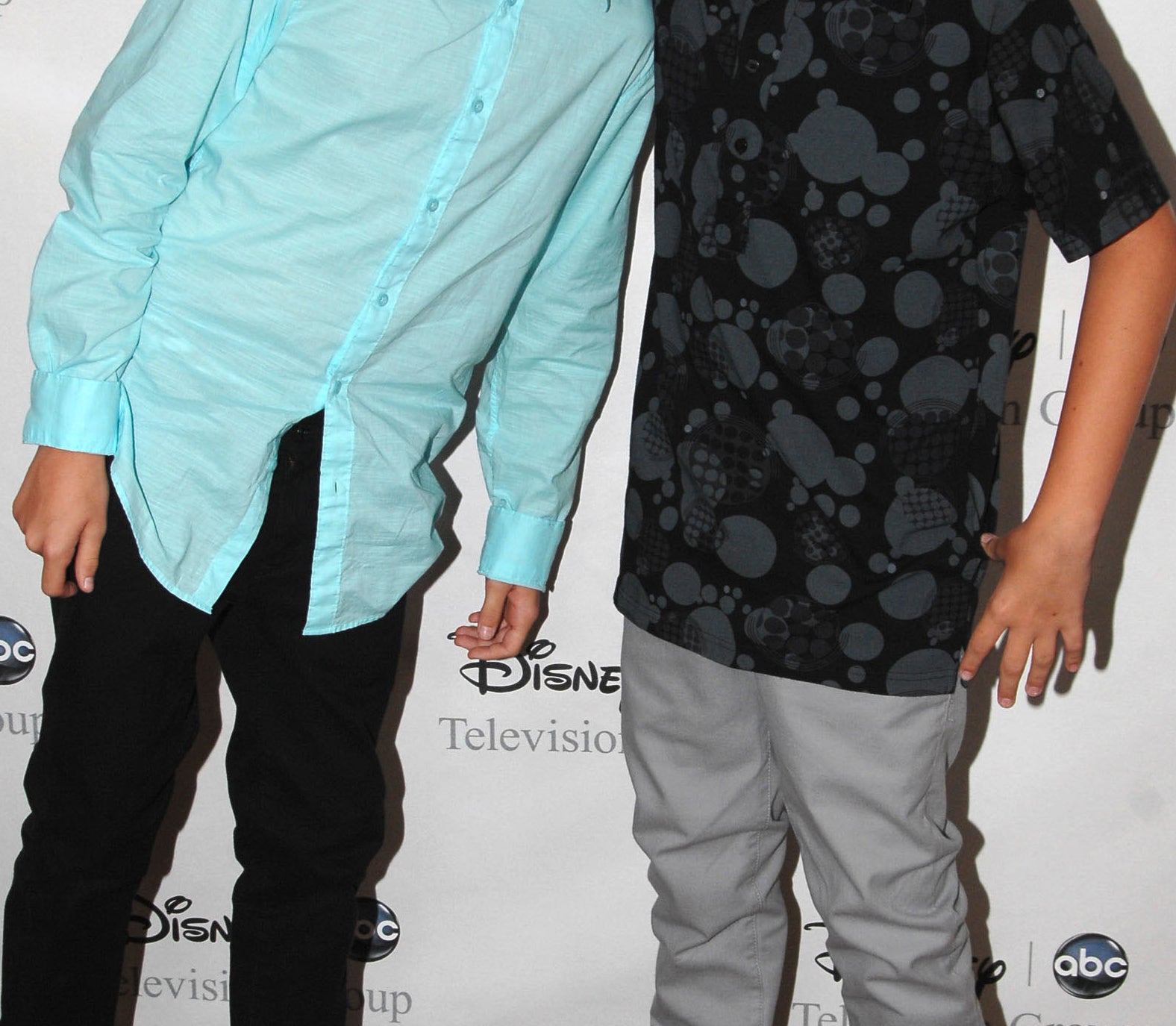 Close-up of Dylan and Cole as kids smiling at a media event