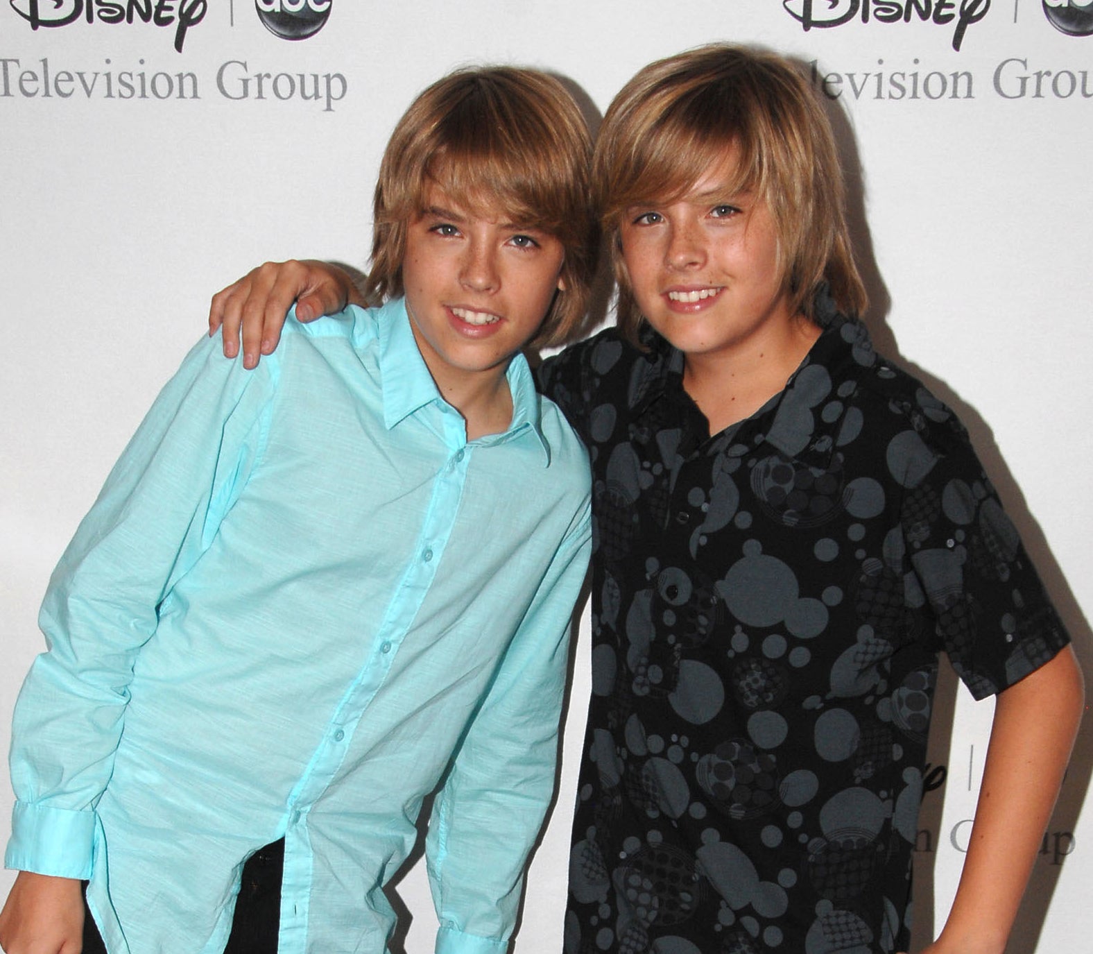 Close-up of Dylan and Cole as kids smiling at a media event