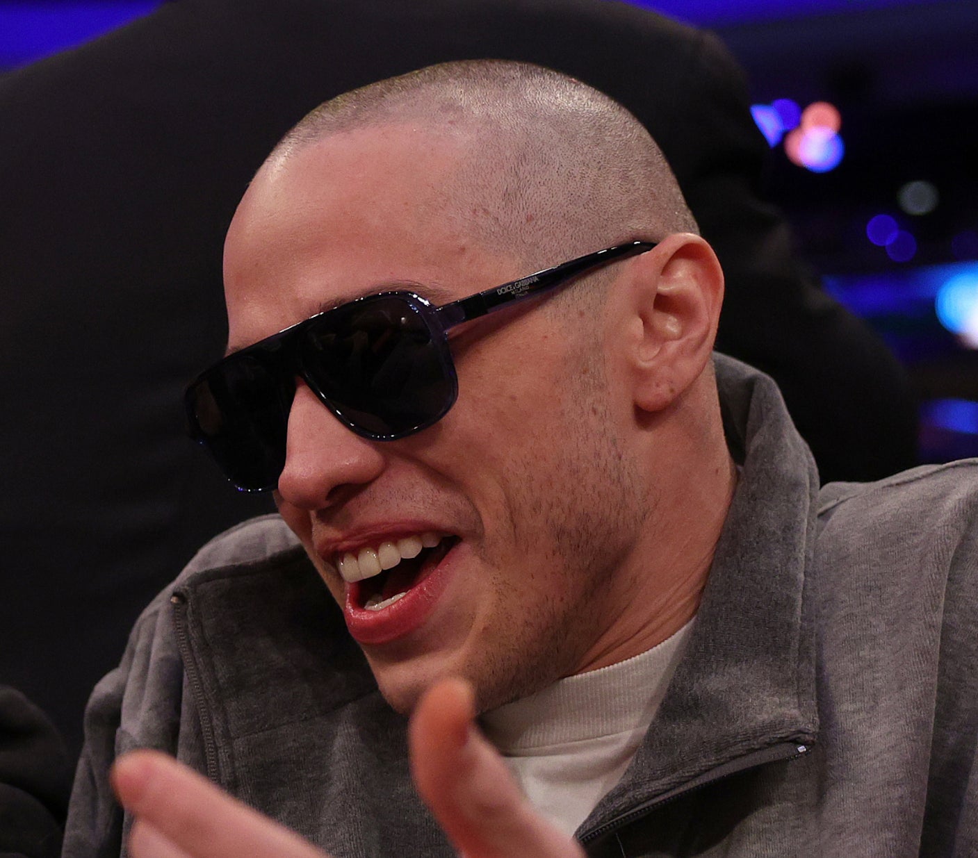 closeup of him with a shaved head wearing sunglasses