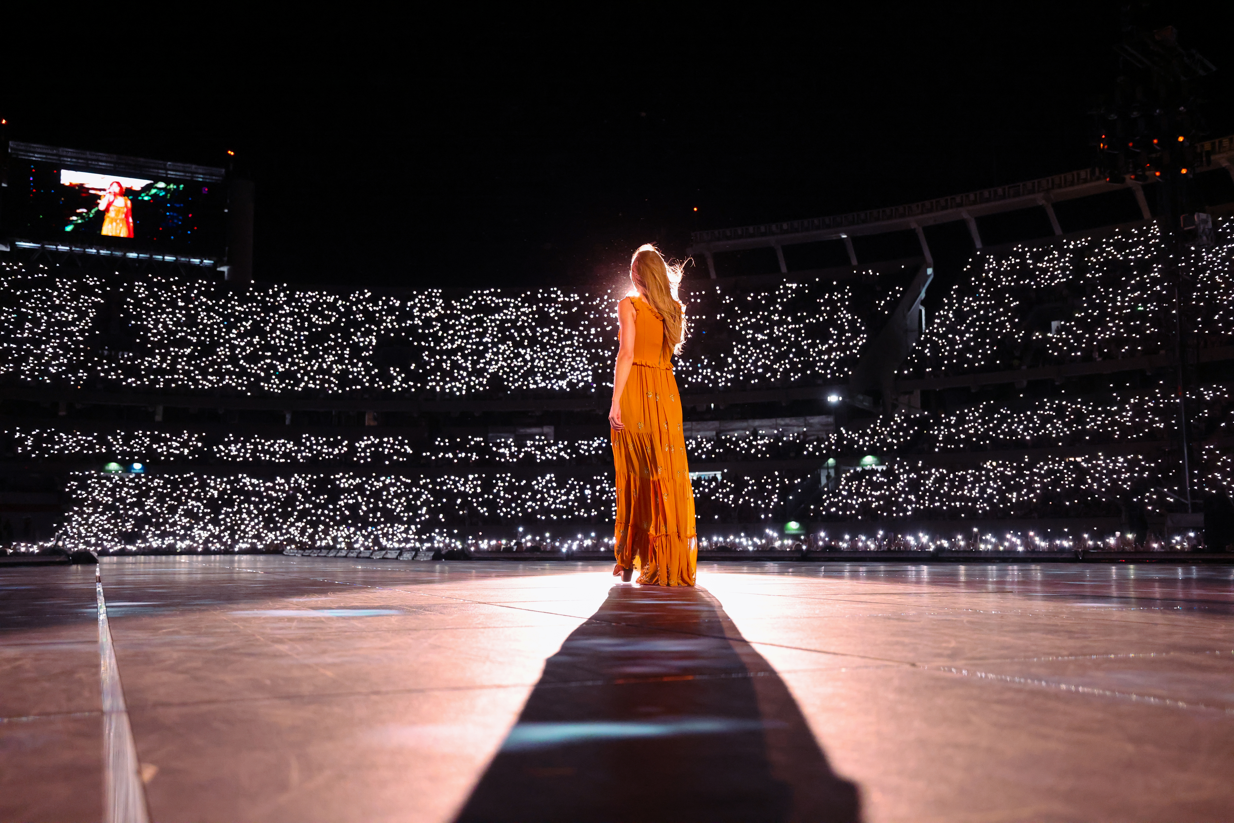 Close-up of Taylor performing at a huge arena