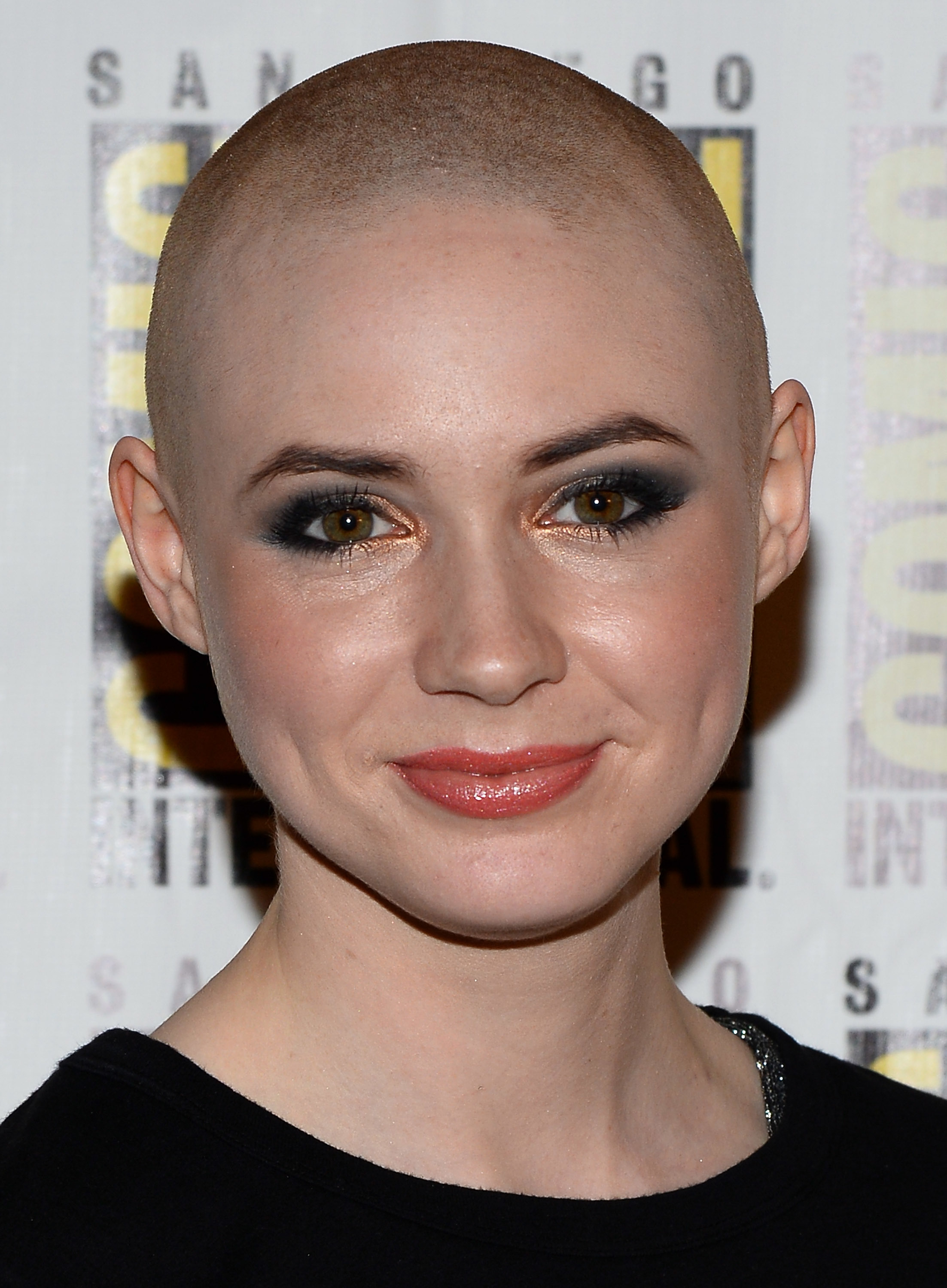 closeup of her shaved head