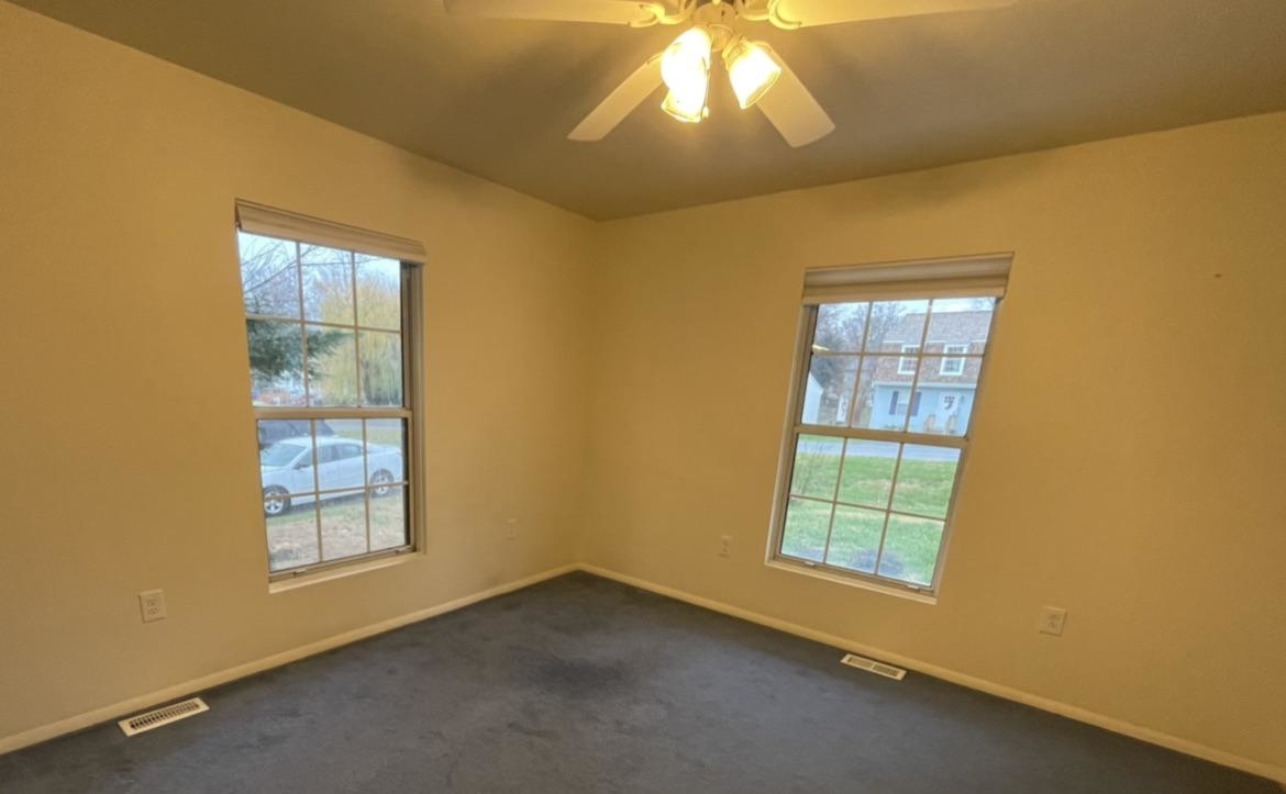 room with two windows that don&#x27;t have trim outside of the frame