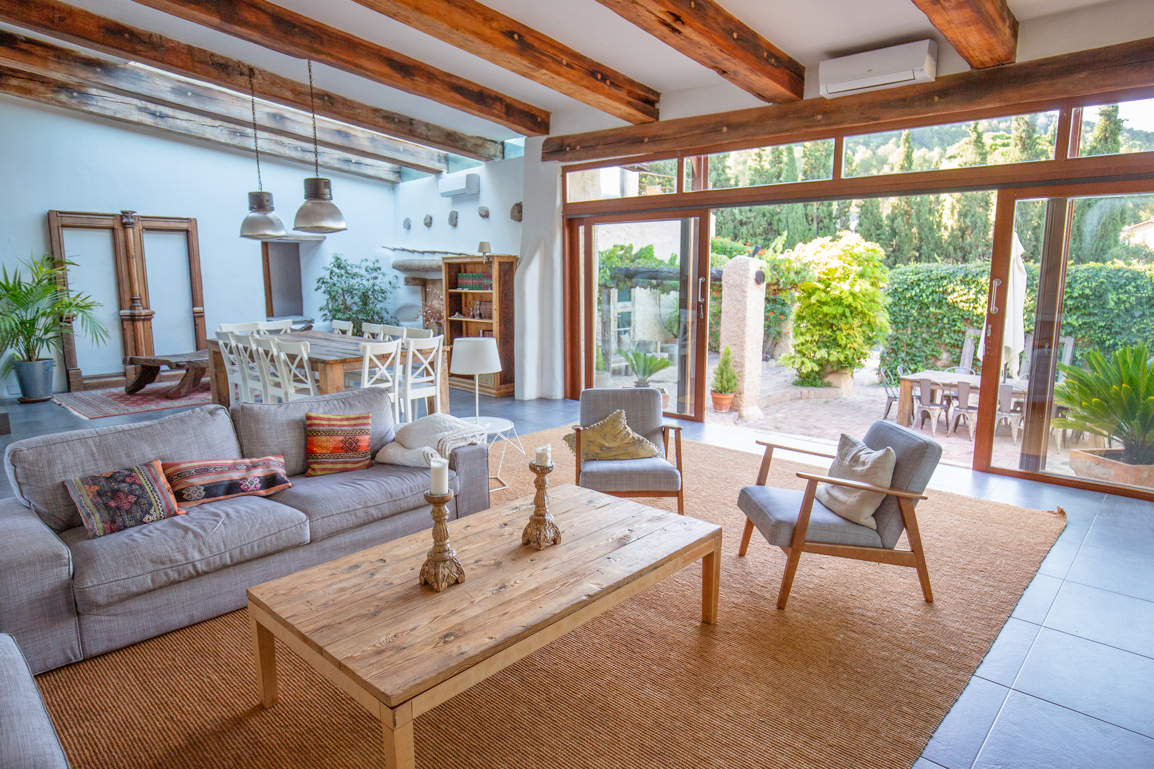 large living room with exposed wood beams lined up against the ceiling