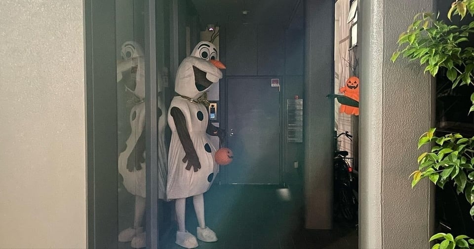 snowman costume someone is wearing to greet people at the door is a little creepy