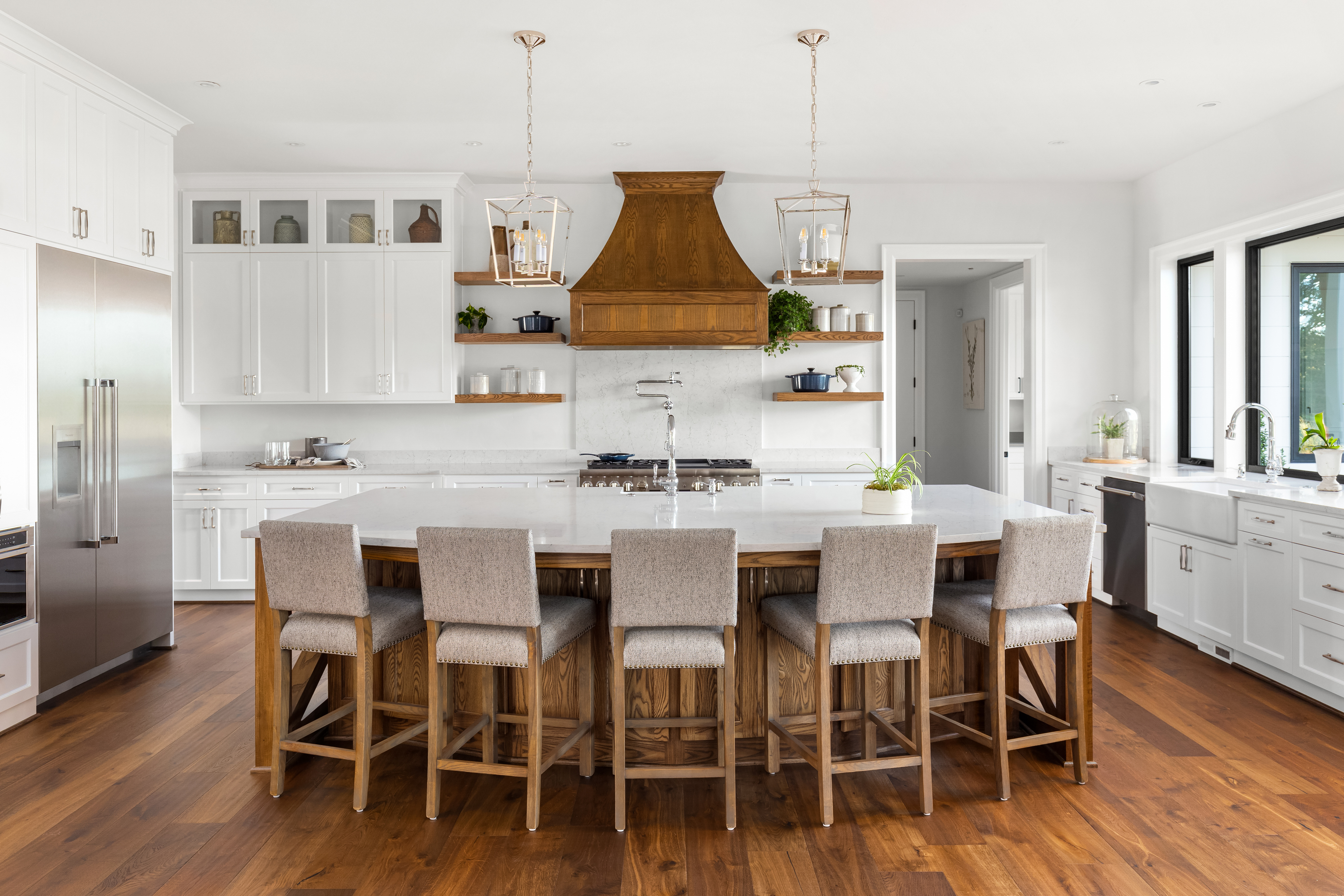 large kitchen island in modern kitchen with bar stools for eating