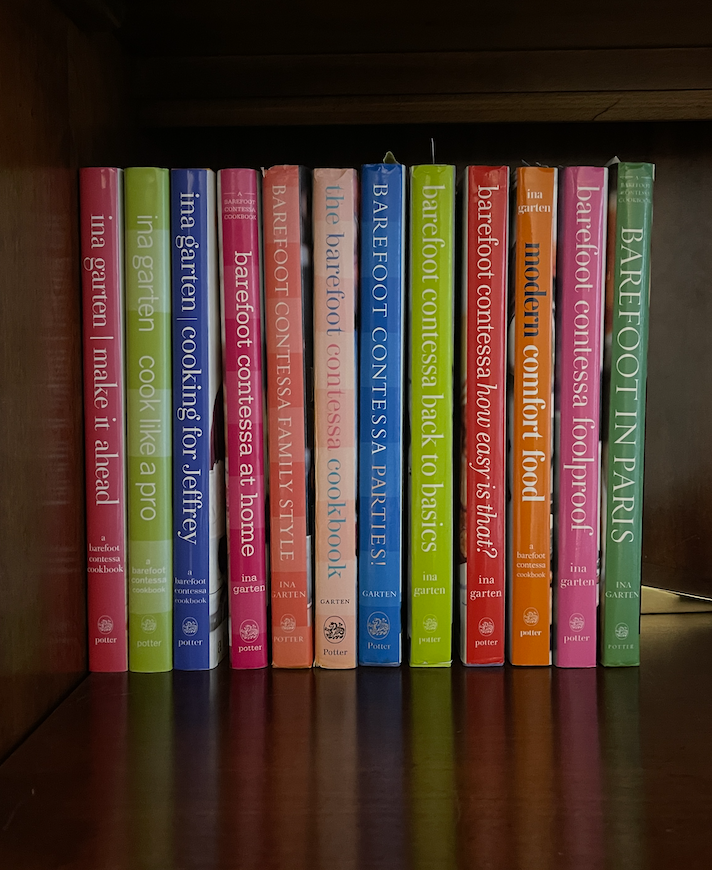 Bookshelf with 12 different Ina Garten cookbooks