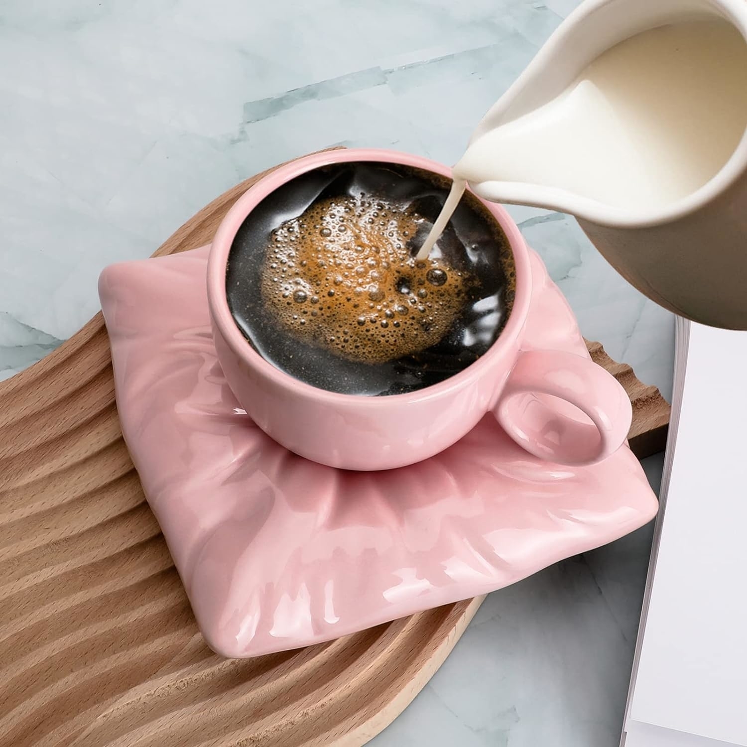 pink teacup on pillow saucer