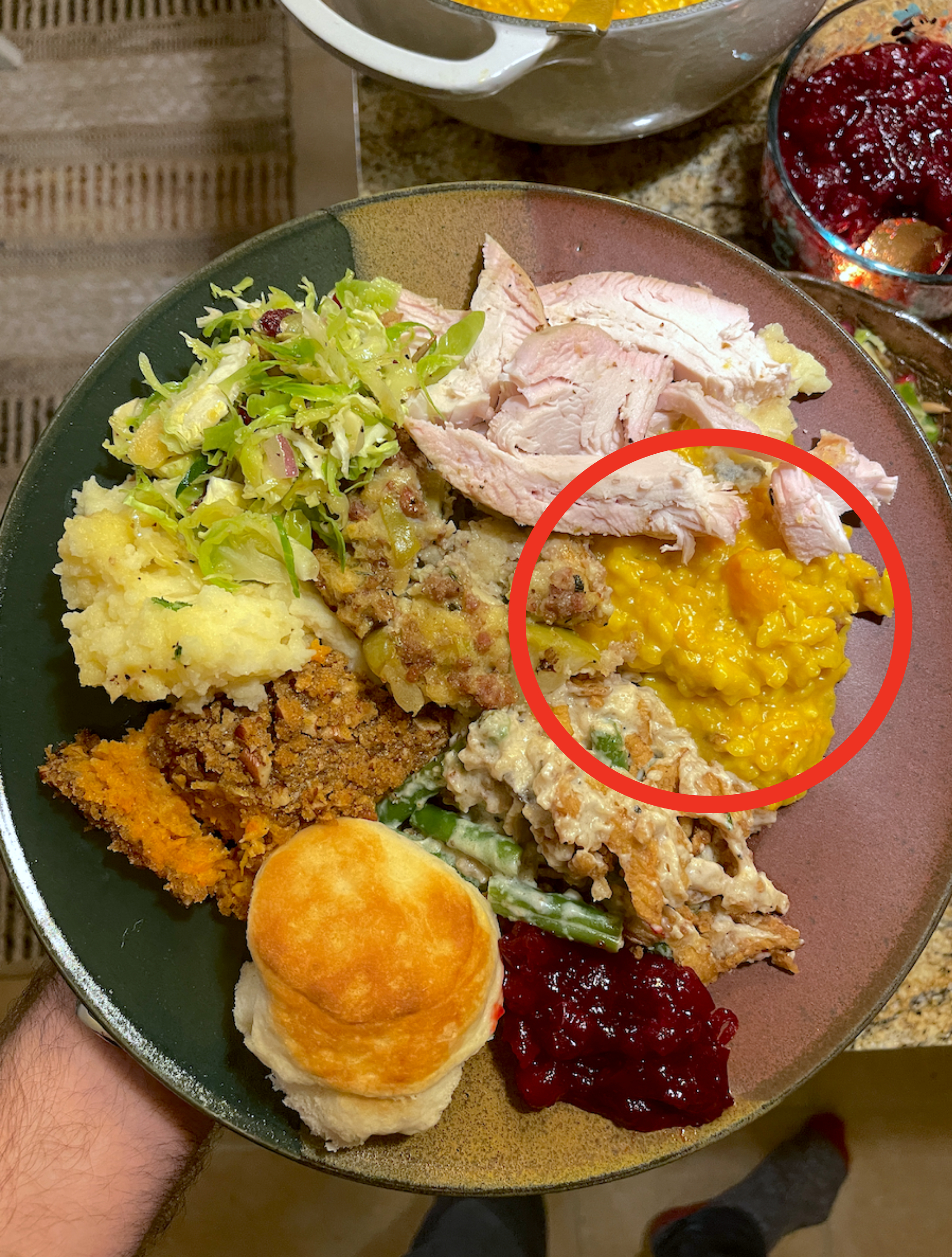 A plate with lots of Thanksgiving sides and the risotto on one side, circled