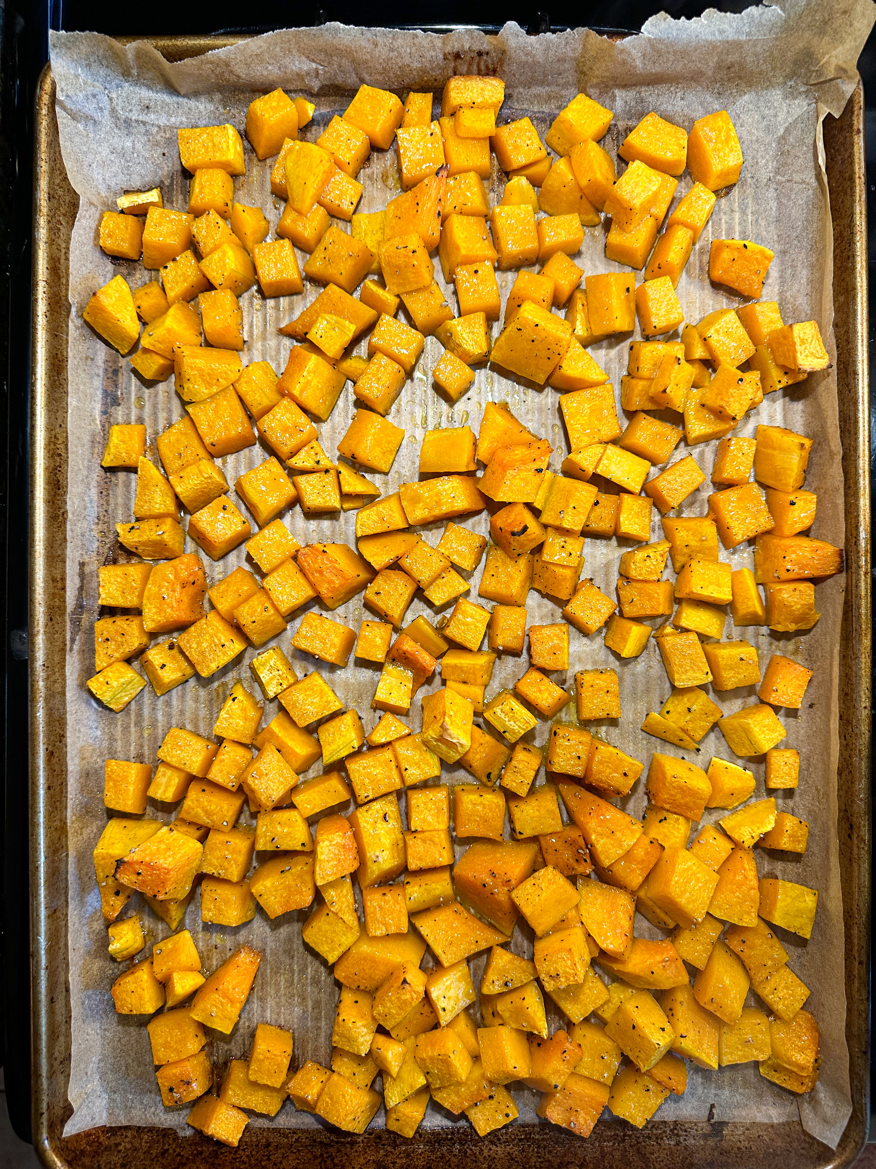 Diced butternut squash on a sheet pan, roasted