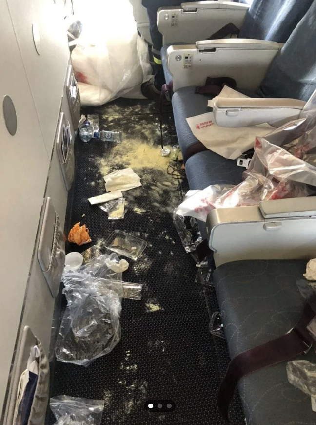 trash all over the floor of an airplane