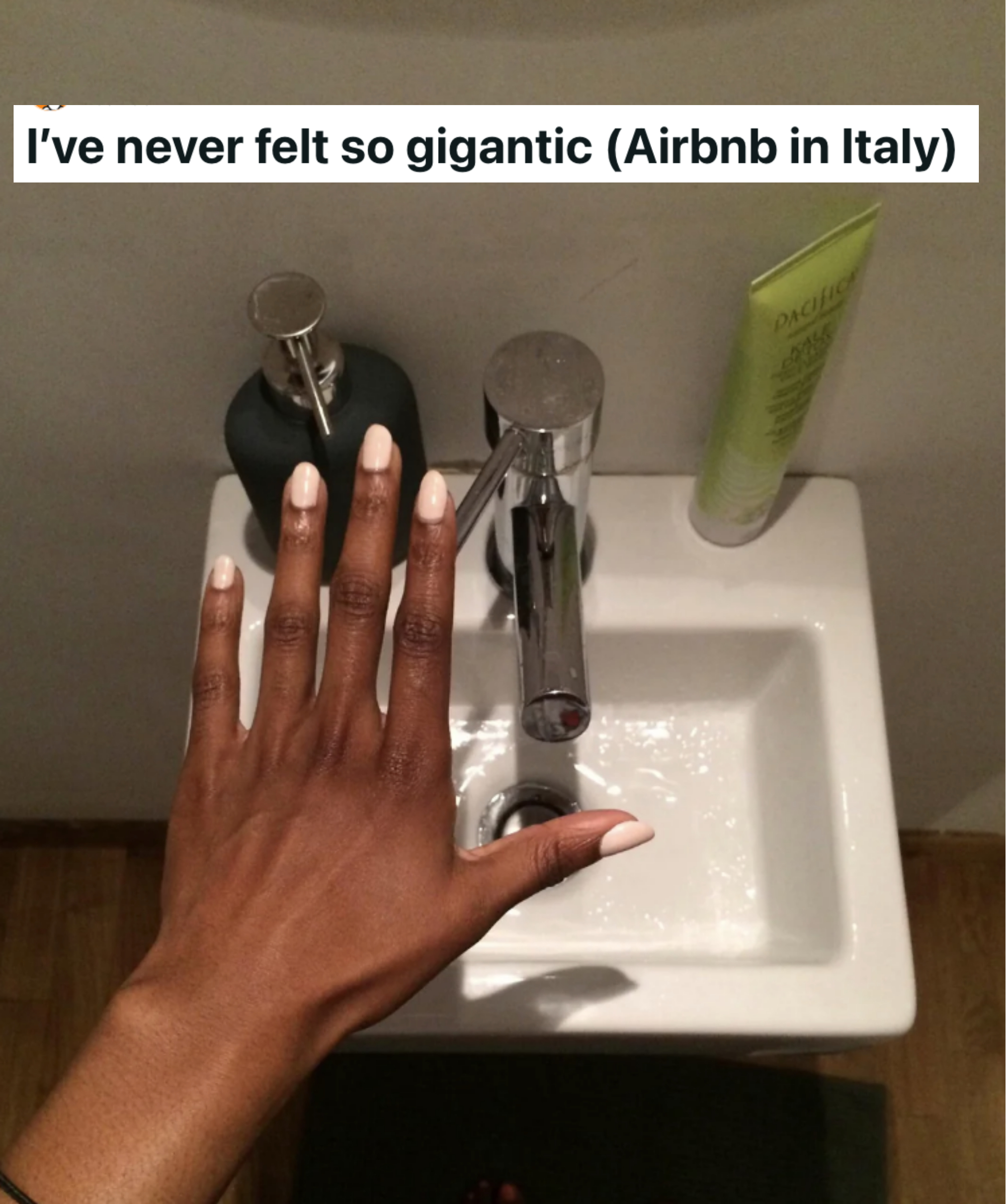 a hand hovering over a tiny sink