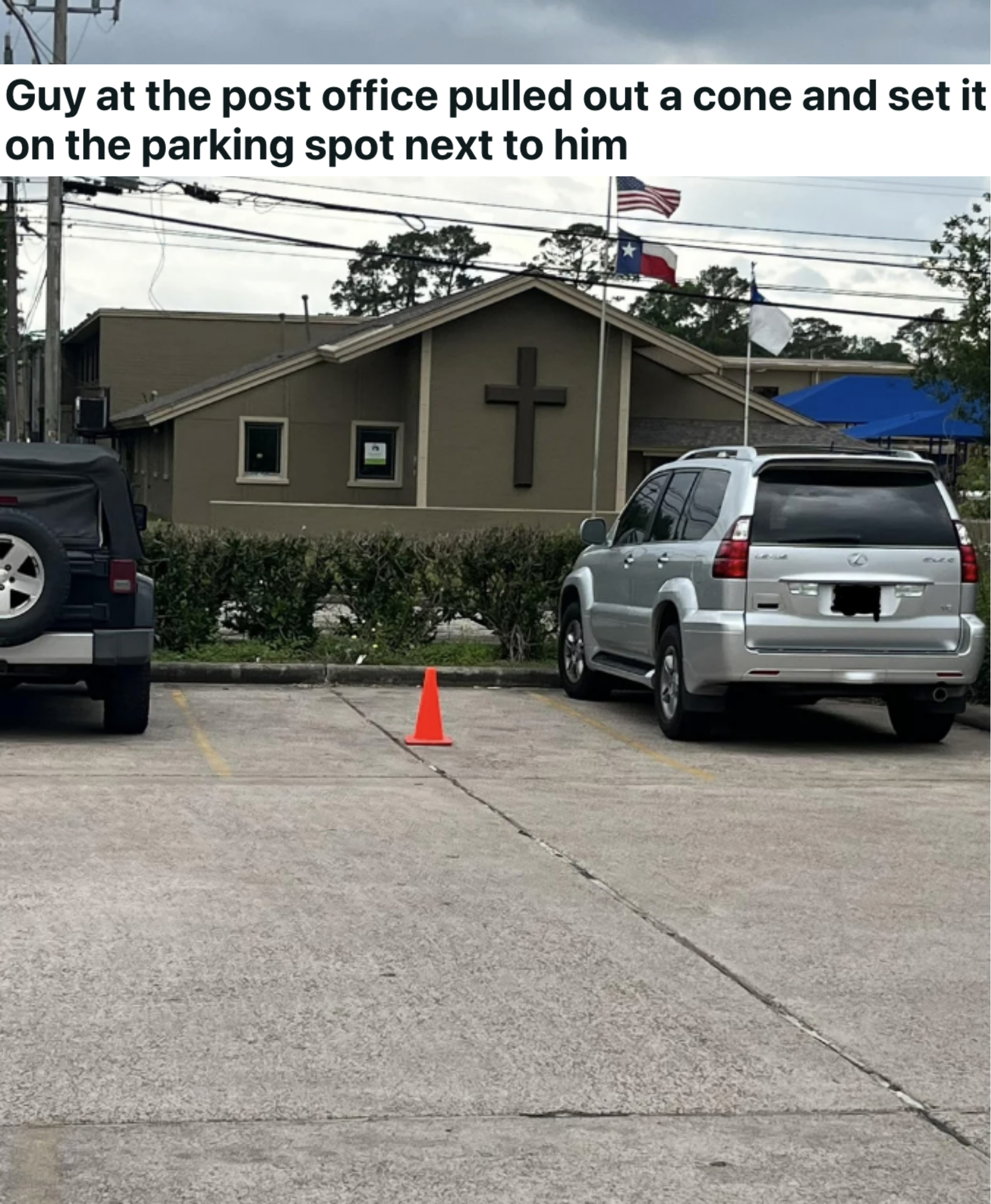 an orange cone blocking a parking spot