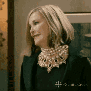 GIF of Moira Rose making a cringy face
