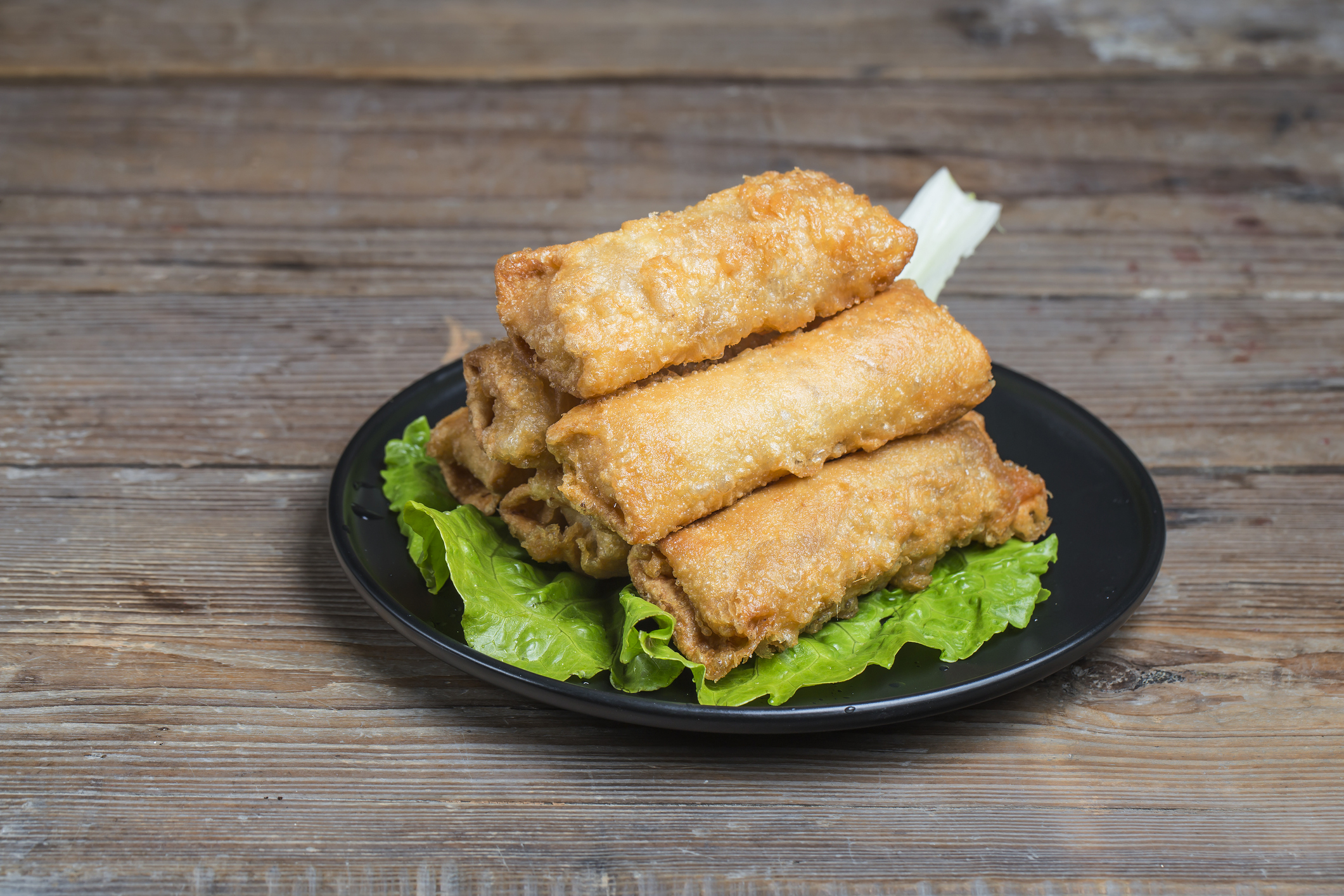 a stack of egg rolls on a plate