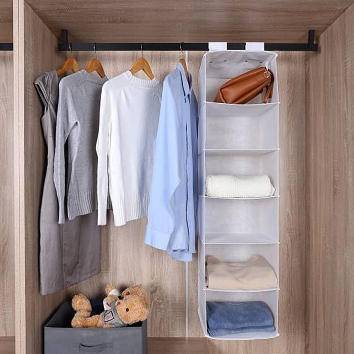 a white fabric shelf system hanging in a closet