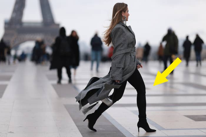 person walking in Paris with a heel boot pant with the Eiffel Tower in the background