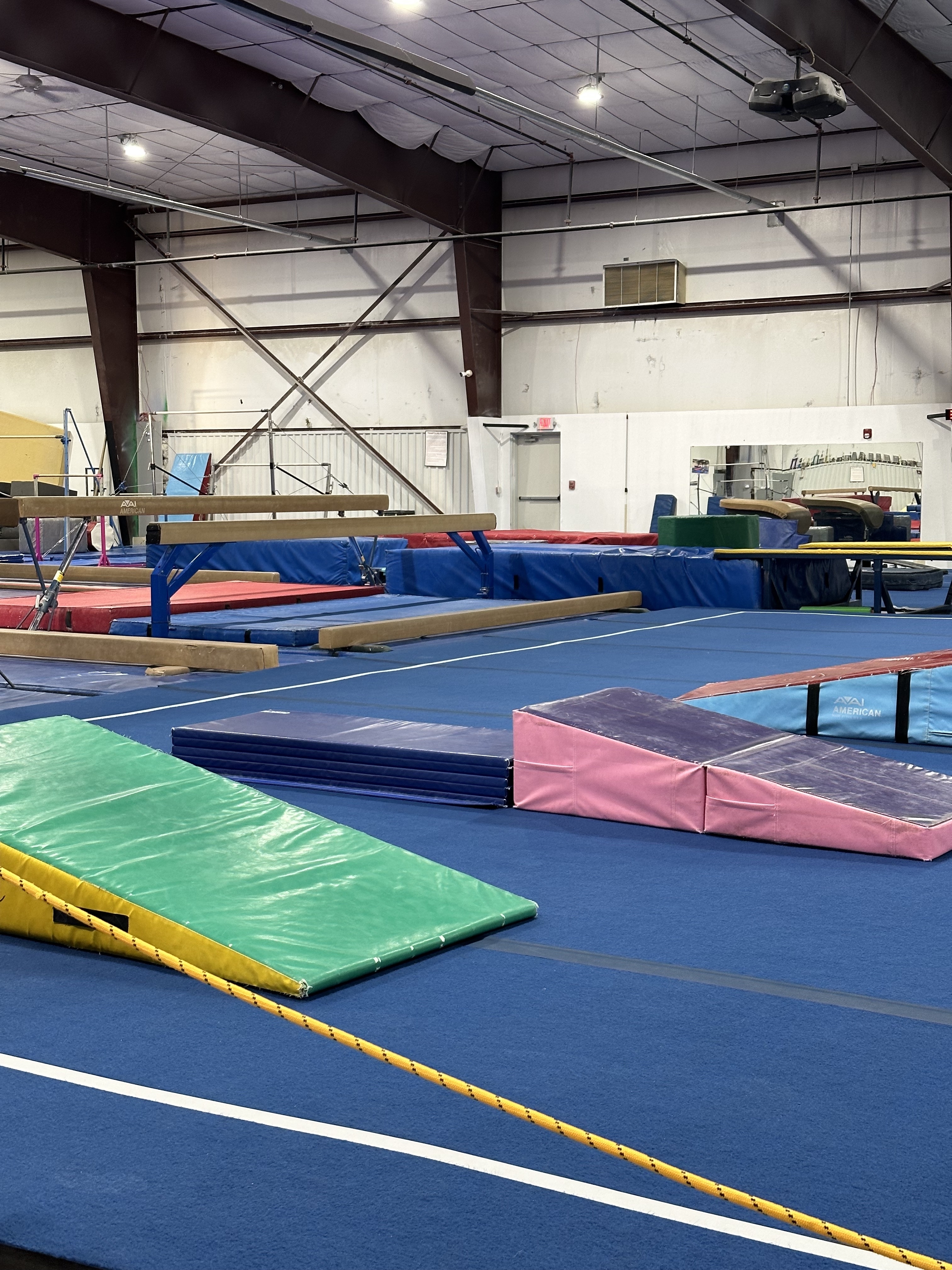 a gymnastics gym filled with equipment