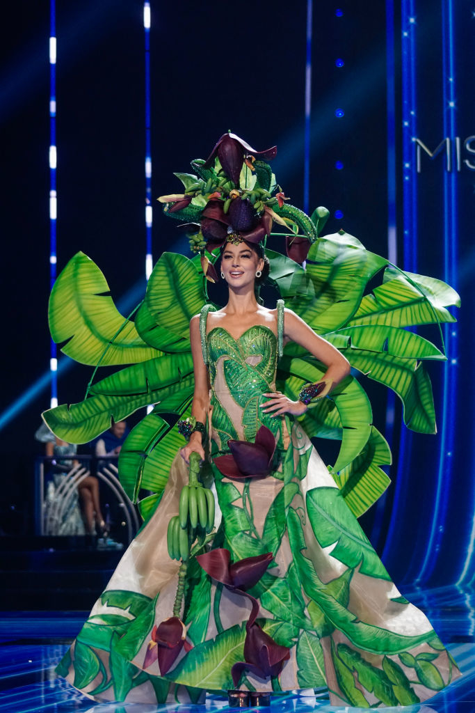She&#x27;s wearing a leaf-print flared gown and leafy train