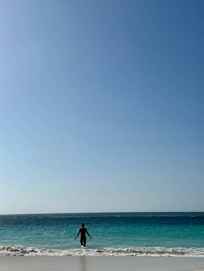 A woman frolicking in Eagle Beach