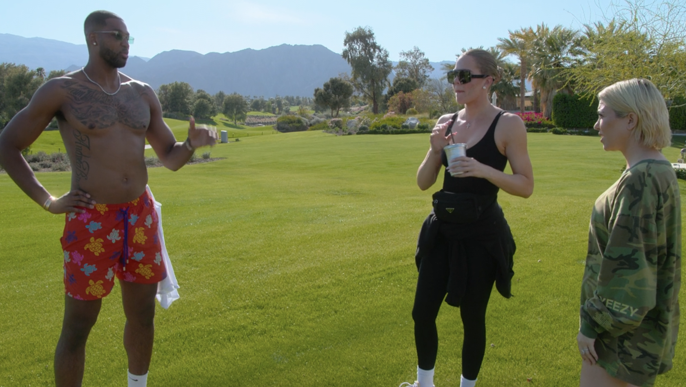 Close-up of Khloé and Tristan standing on grass