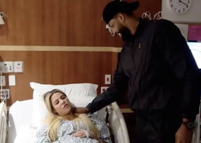 Close-up of Tristan standing over Khloé in a hospital bed
