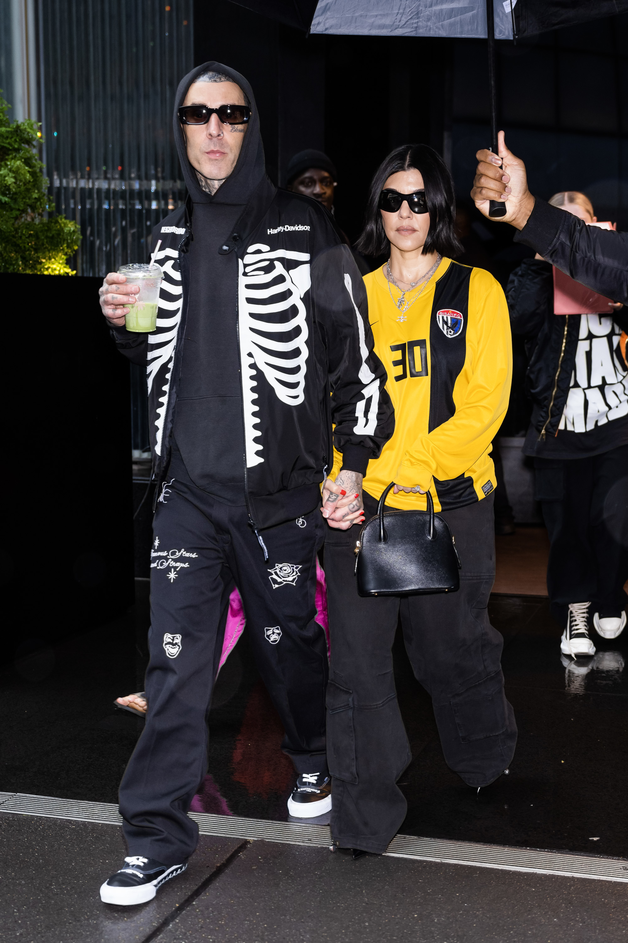 Close-up of Travis and Kourtney holding hands