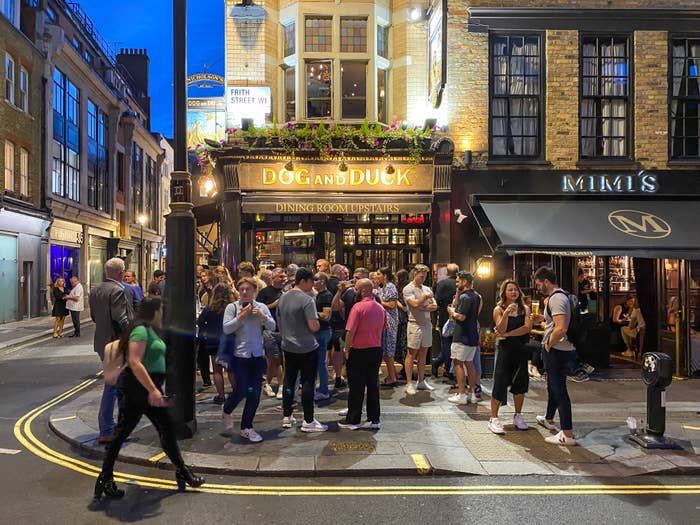 a crowd around a british pub at night