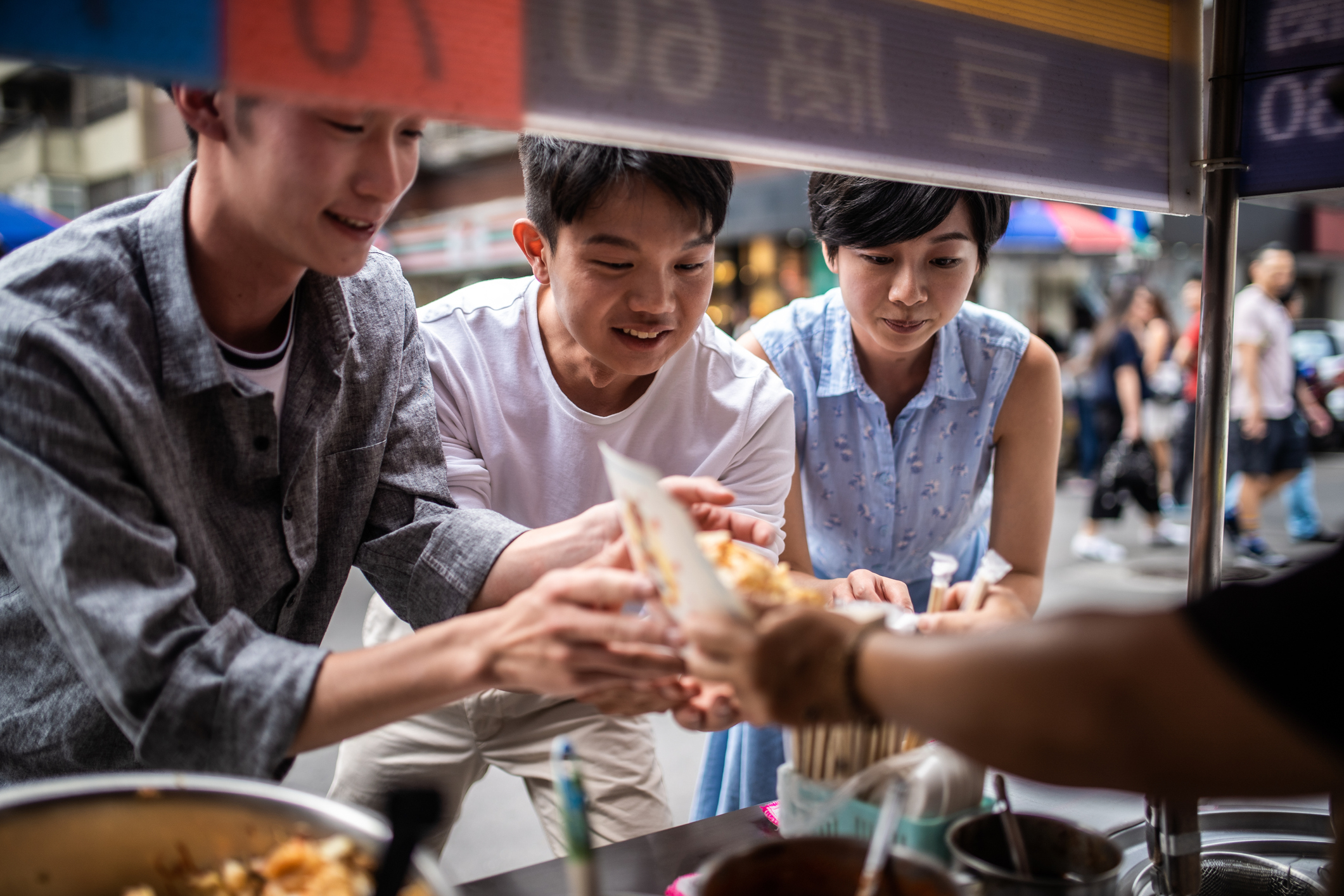 people ordering food from a street market in taiwan