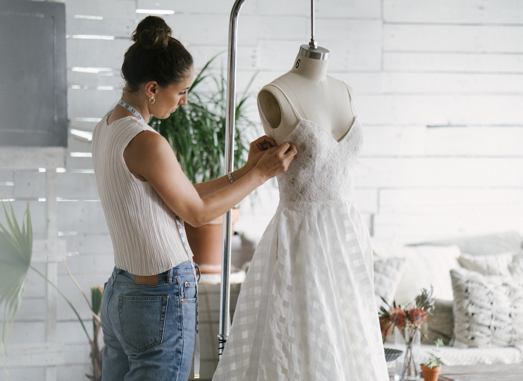 stylist tailoring a wedding dress