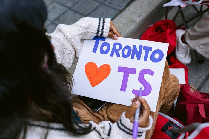 Fan holds a sign that says TORONTO Loves TS.