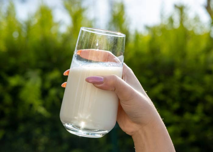 person holding a glass of milk