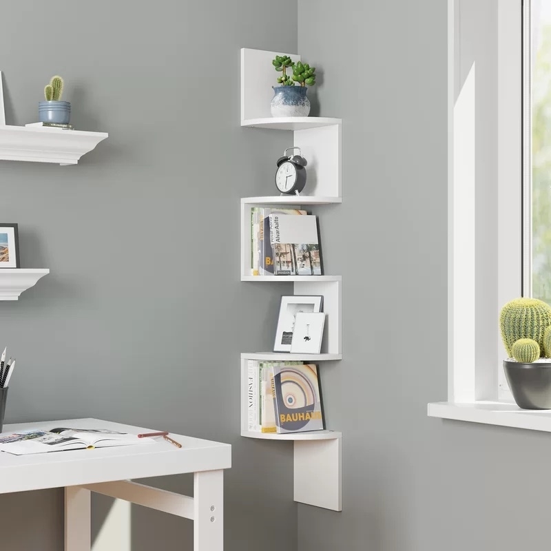 bookcase mounted to wall with books and other accessories