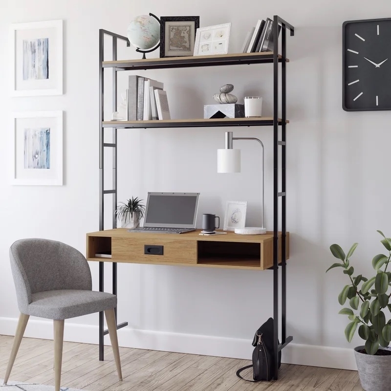 mounted desk with laptop, books, and other decor