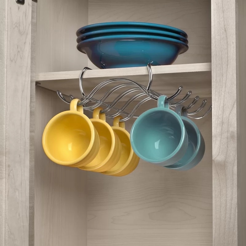 hooks attached to cabinet shelf and holding multiple mugs
